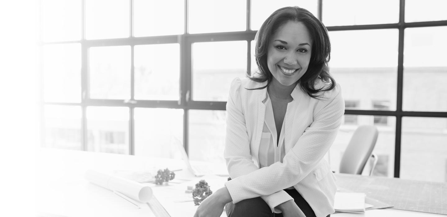 A woman in a suit smiling at the camera